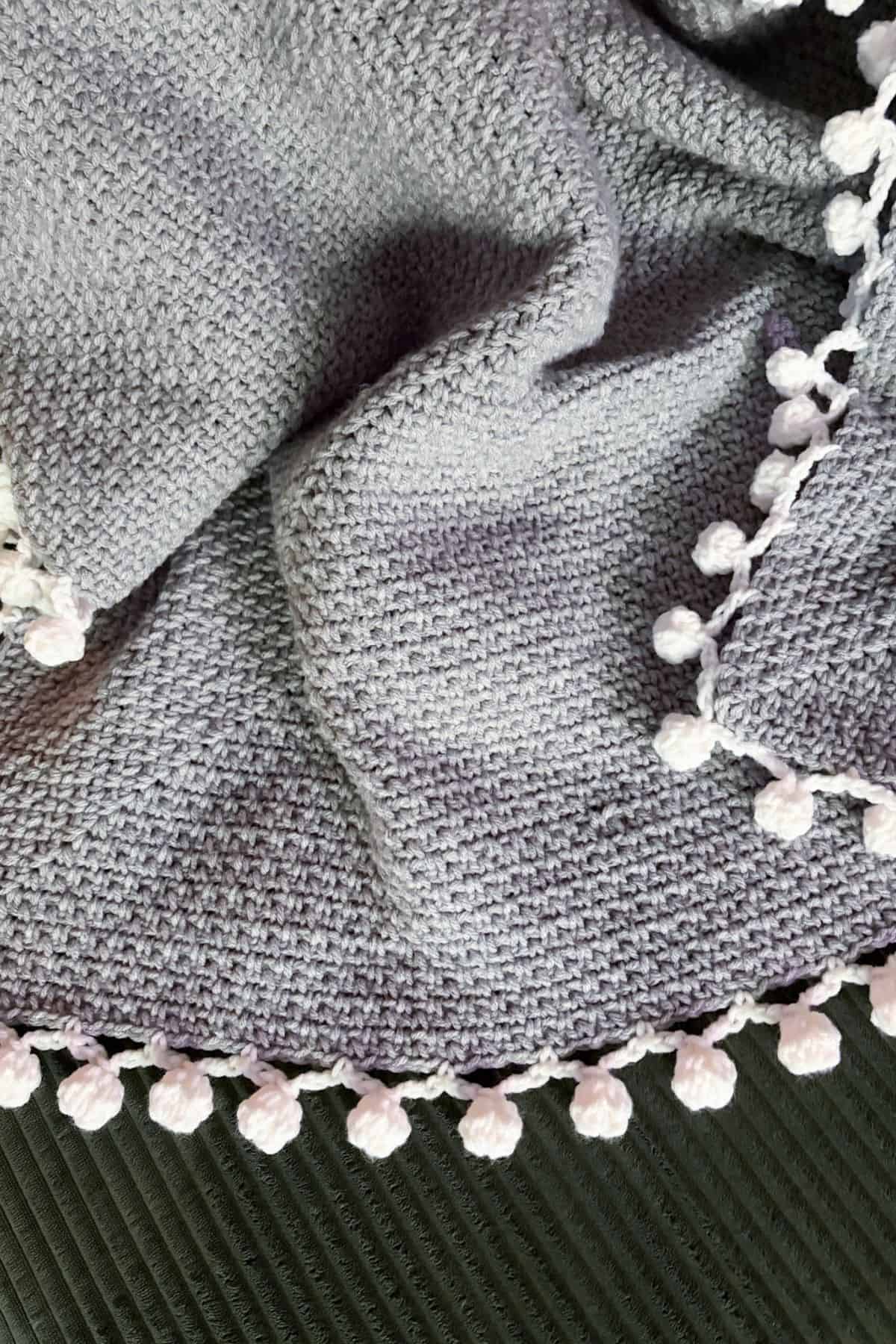 Finished crochet linen stitch blanket on couch.