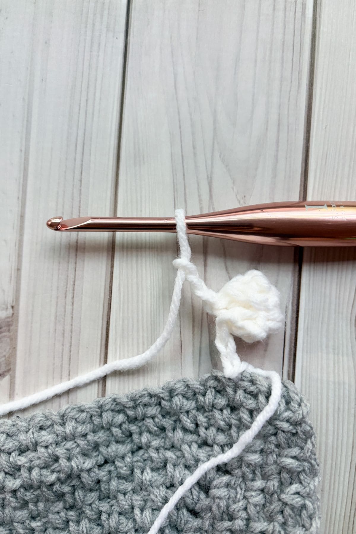 Finished crochet pom pom.