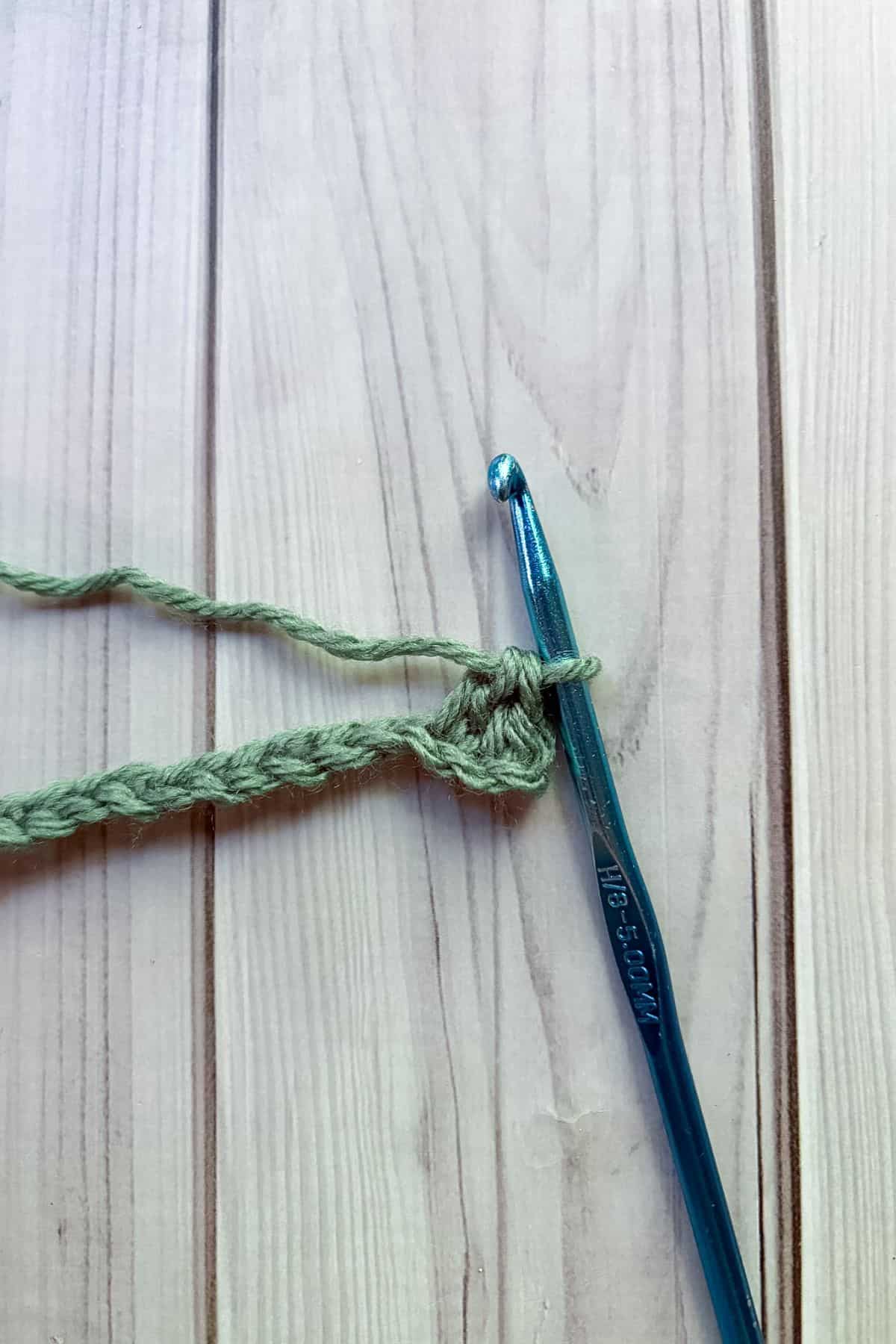 After making a single crochet and then a dc in the next stitch.