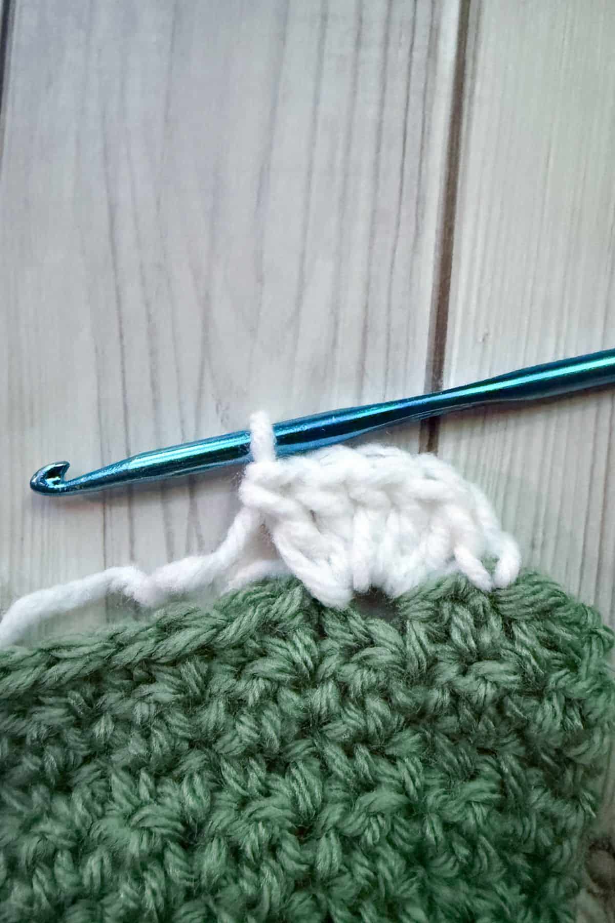 Showing 5 double crochet stitches in 1 stitch.