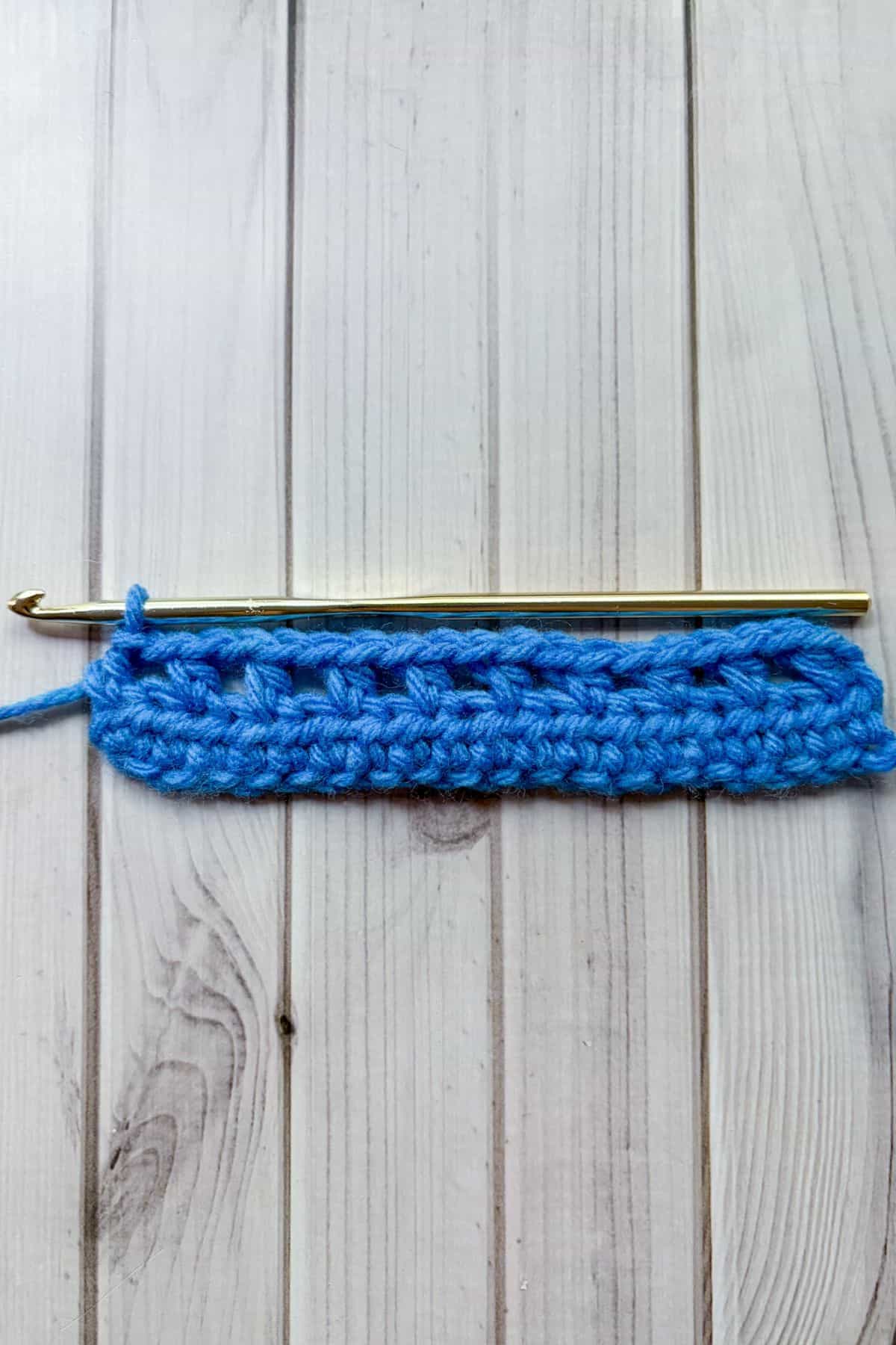 Row of half double crochet with chain one windows.