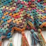 Finished crochet granny ripple blanket with tassels.