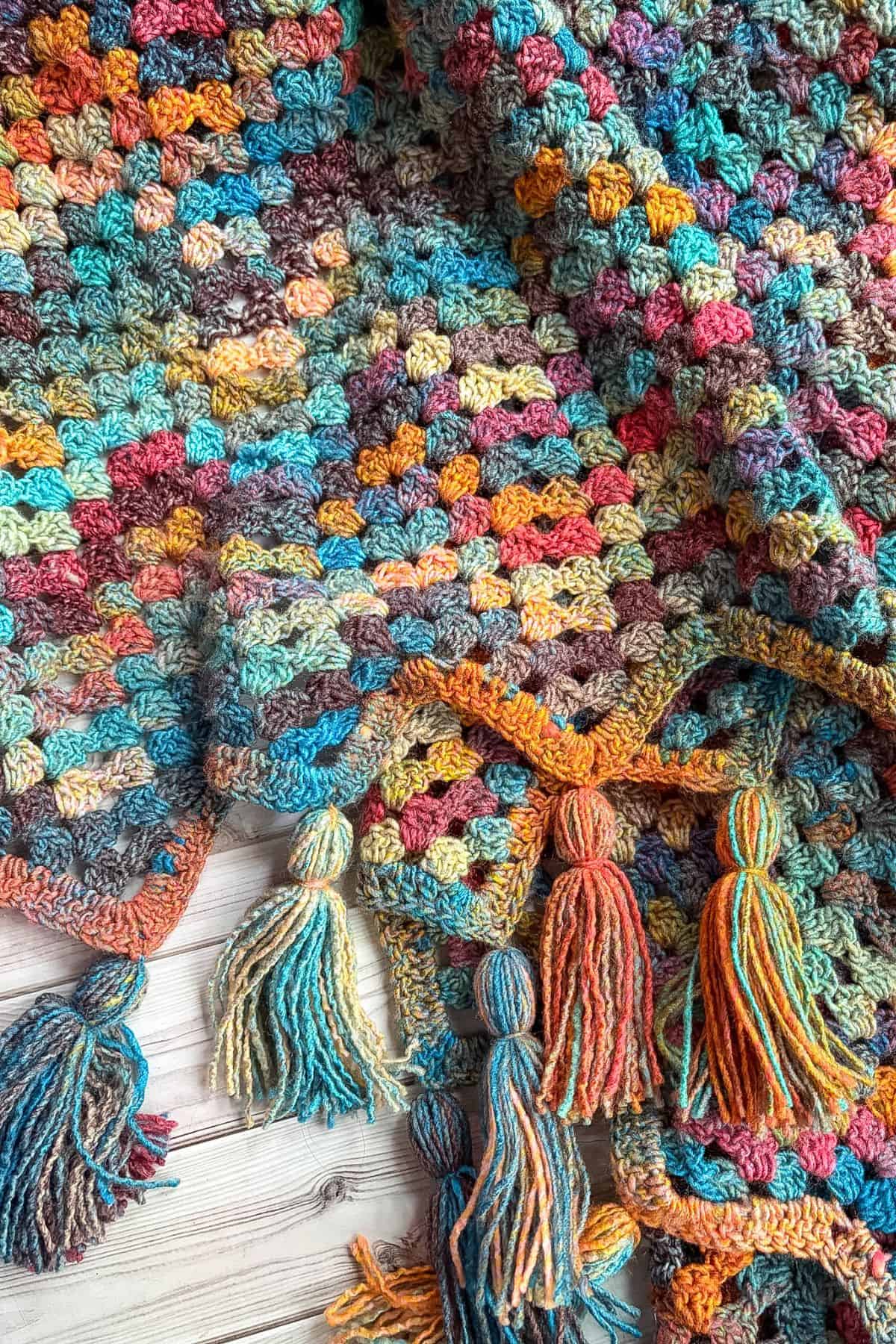 Finished crochet granny ripple blanket with tassels.