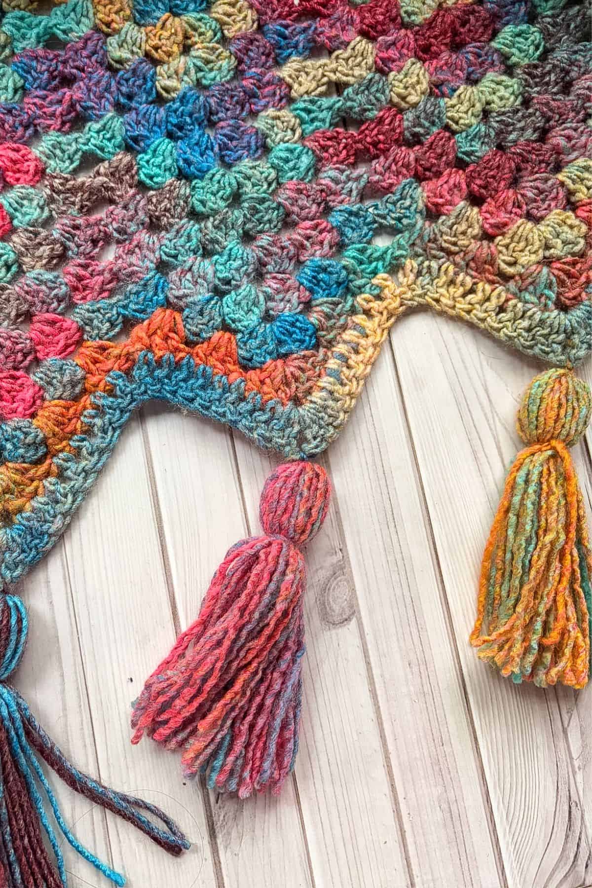 Finished crochet granny ripple blanket with tassels.