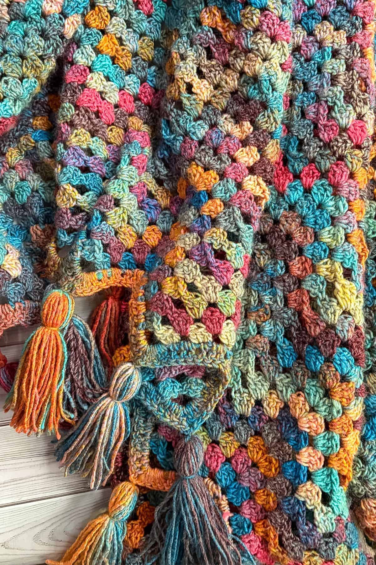 Finished crochet granny ripple blanket with tassels.