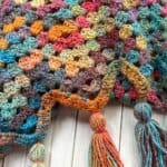 Finished crochet granny ripple blanket with tassels.