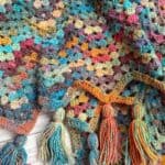 Finished crochet granny ripple blanket with tassels.