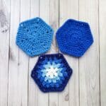 3 finished crochet hexagons on a table.