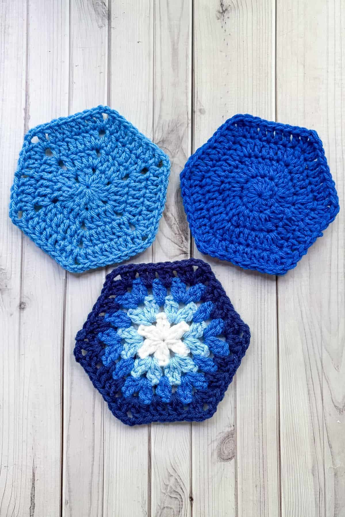 3 finished crochet hexagons on a table.