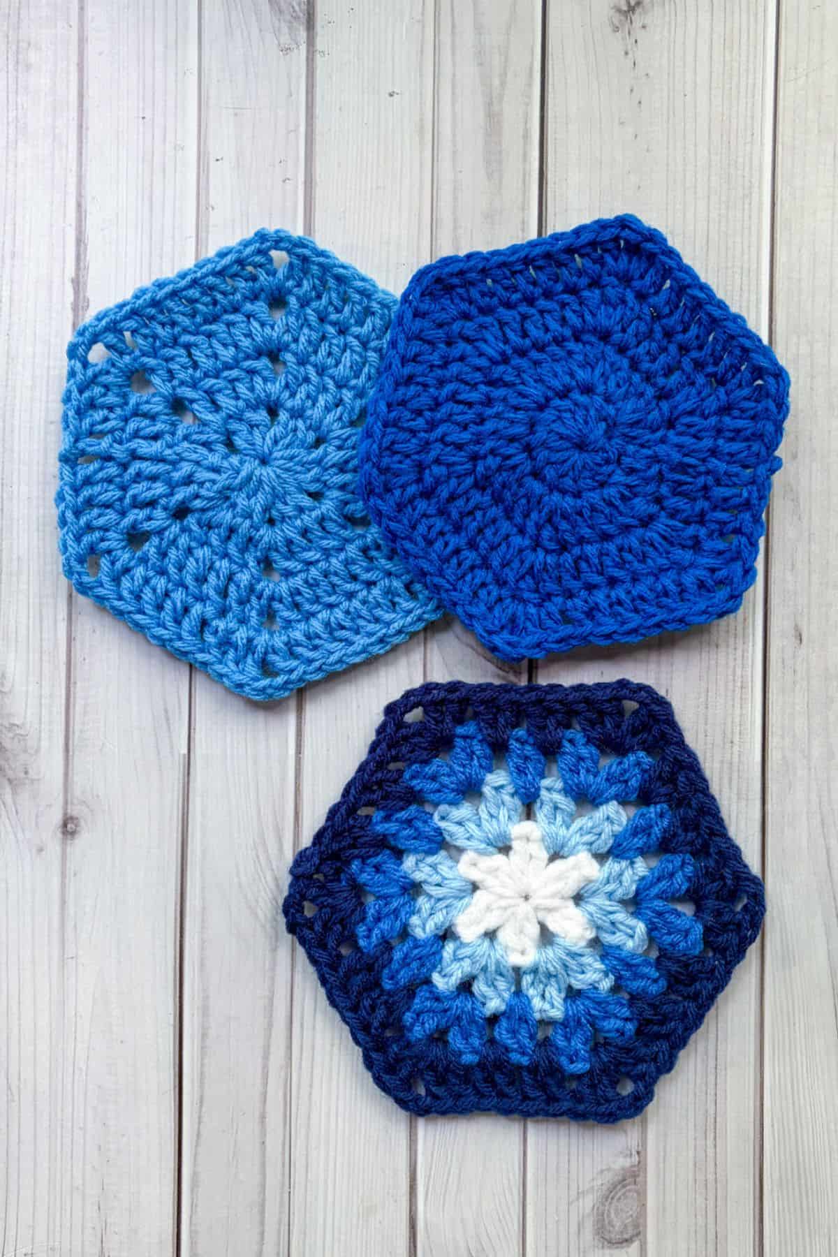 3 finished crochet hexagons on a table.