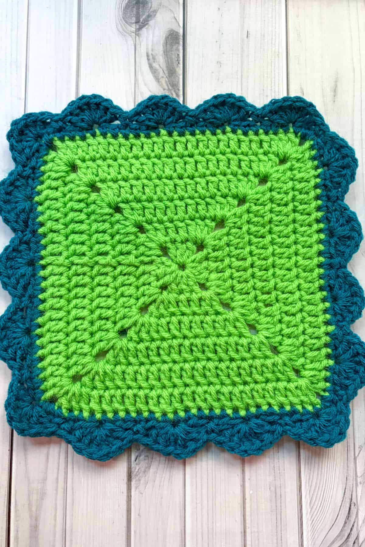 Square with scalloped crochet border.