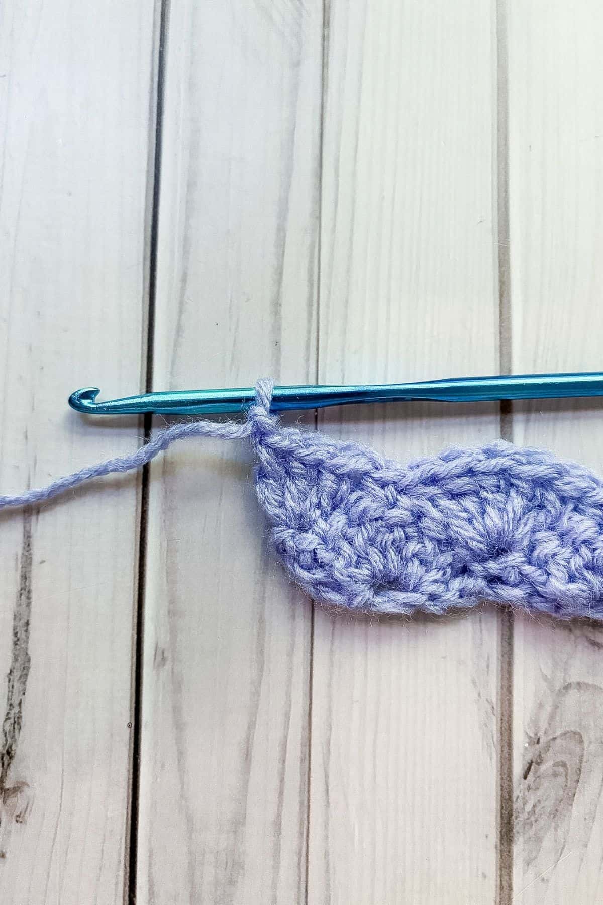 Completed second row of crochet shell stitches.