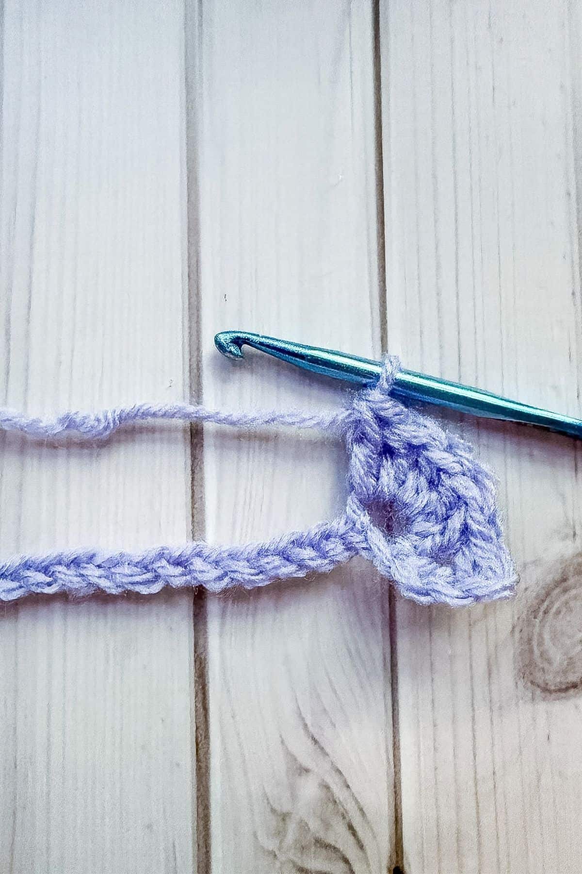 Making 5 dc stitches in one stitch.
